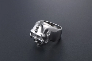 Close-up of punk skull ring with spike details on forehead made of polished titanium steel