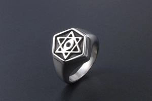 Macro detail of men's vintage steel ring with star and all-seeing eye engraving