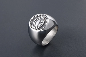 Detailed close-up of retro stainless steel signet ring with gothic eye totem engraving