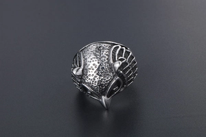 Macro shot of retro owl ring with detailed feather texture and vintage silver finish