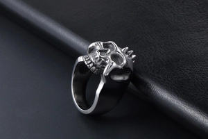 Detailed macro view of punk style skull ring with intricate stainless steel carvings