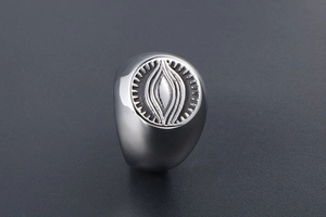 Macro shot of silver vintage eye of providence signet ring with radial engravings