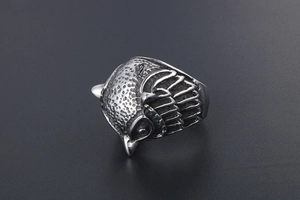 Detailed view of vintage owl ring featuring intricate feather patterns and sharp hawk beak