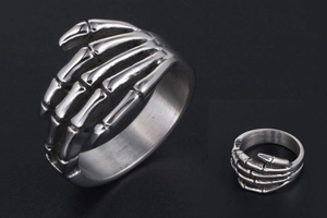 Detailed macro shot of vintage punk skull hand ring with aged stainless steel finish
