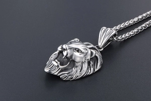 Détail macro du pendentif tête de lion rugissant avec crinière texturée et fini argenté