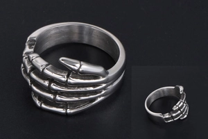 Macro shot of punk skeleton hand ring featuring vintage oxidized steel craftsmanship