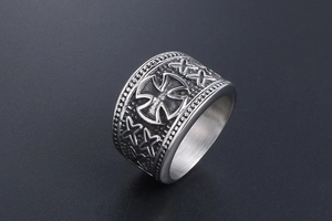 Detail of vintage maltese cross relief on wide steel ring with beaded edges