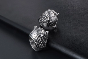 Detailed view of vintage owl rings showing intricate feather carvings on silver steel