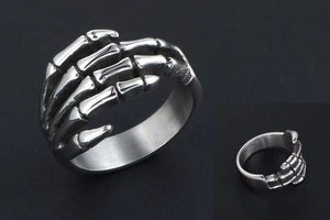 Detailed view of punk style stainless steel skeleton hand ring with vintage finish