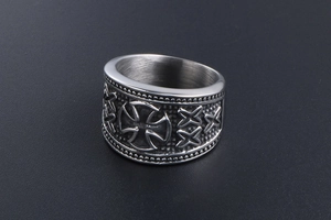 Detail of vintage iron cross titanium steel ring with embossed patterns and bead edges