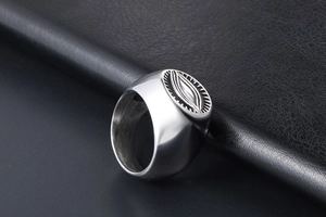 Macro view of vintage silver steel ring with embossed eye geometric texture details