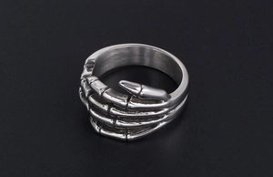 Detailed view of punk skeleton hand ring in antique silver finish with dark bone textures