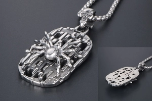Macro view of vintage spider shield pendant and skull clasp with pearl chain