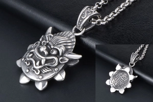 Detailed view of silver dragon head pendant with vintage matte finish and carved details