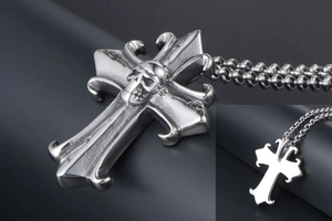 Macro shot of gothic cross pendant with skull detail and aged silver finish texture
