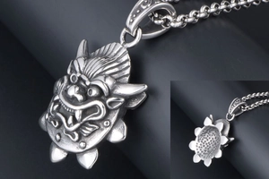 Detailed macro of vintage silver dragon pendant with antique finish and chunky chain