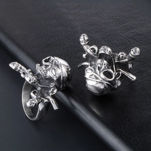Men's titanium steel pirate skull rings with dagger details on black leather background