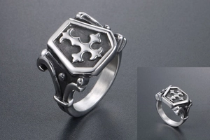 Close-up of vintage shield cross ring with polished steel finish and gothic textures