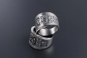 Detailed view of stacked vintage titanium steel rings with cross relief and retro texture