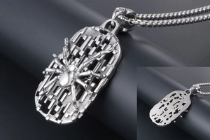 Detail of vintage gothic spider shield pendant with geometric hollow pattern on bead chain
