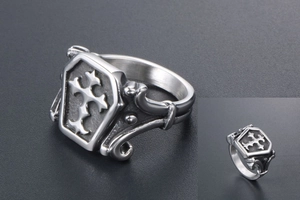 Macro shot of retro stainless steel shield ring with gothic cross and scroll relief