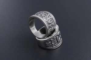Detailed close-up of retro gothic iron cross rings with aged titanium steel texture