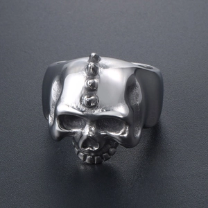 Punk style stainless steel skull ring with 4 spikes and a vintage metallic finish
