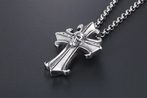 Macro view of gothic skull relief on a cross pendant made of polished stainless steel