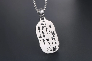 Close-up of gothic punk skeleton connector and hollow silver geometric pendant