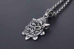 Macro shot of detailed mythical dragon head pendant with vintage gothic steel finish