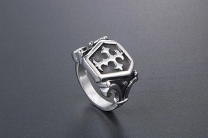 Detail of retro titanium steel ring featuring a gothic cross shield and scrollwork engraving
