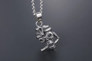 Macro detail of gothic skull necklace with cobra and dagger in antique steel finish
