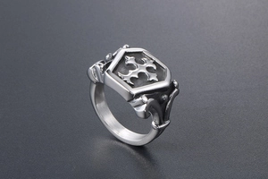 Detailed macro view of retro gothic shield ring featuring engraved cross and steel texture