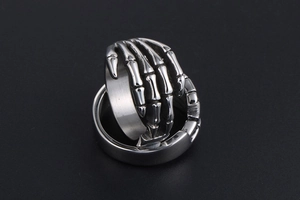 Macro detail of vintage punk skeleton hand ring made of silver-tone stainless steel