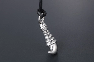 Detailed close-up of retro silver wolf tooth pendant with intricate scale textures