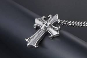 Macro shot of gothic cross skull pendant with vintage punk stainless steel chain