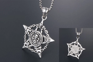 Macro detail of gothic skull pendant with pentagram and eye of providence symbols