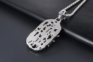Macro detail of industrial punk spider shield pendant with skull bail and chunky chain