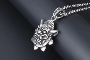 Macro view of vintage stainless steel dragon head pendant with detailed 3D relief texture