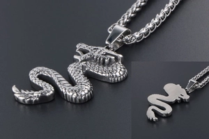 Macro detail of silver dragon pendant showing scales and steel wheat chain texture