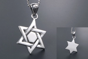 Macro detail of hexagonal star pendant showing polished finish and engraved star clasp