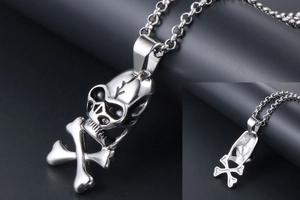 Polished silver skull and crossbones pendant showing front view and hollow back detail