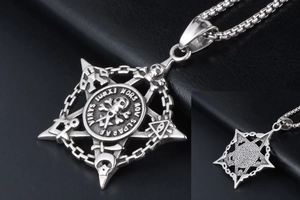 Detail of silver pentagram pendant with skull and mystic occult symbols in punk style