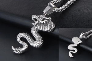 Detailed view of silver dragon pendant showing intricate scales and wheat chain necklace