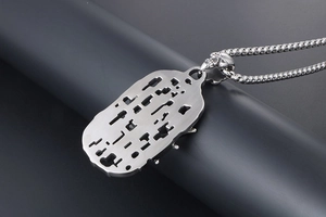 Macro detail of gothic skull connector and hollow shield pendant on steel chain