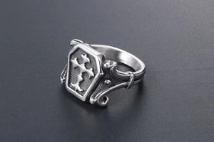 Detailed view of vintage silver coffin ring with embossed cross in gothic punk style