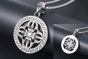 Close-up of vintage titanium steel necklace with Greek key pattern and skull charm detailing