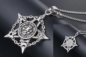 Macro detail of gothic skull pendant with Latin text and vintage stainless steel finish