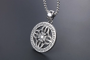 Macro detail of vintage titanium steel necklace with Greek key pattern and skull clasp