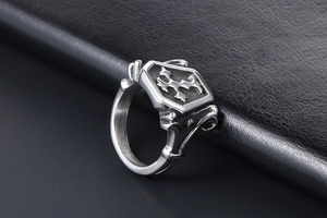 Macro shot of gothic shield ring with cross pattern and vintage finish on black leather